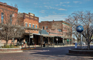 Historic brick storefronts and a cobblestone street in Omaha’s Old Market